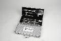 5-piece stainless-steel BBQ set includes spatula with serrated blade and bottle opener, tongs, turning fork, cutting knife, and sauce brush. Tools are secured by straps in carrying case with WSU imprint.
